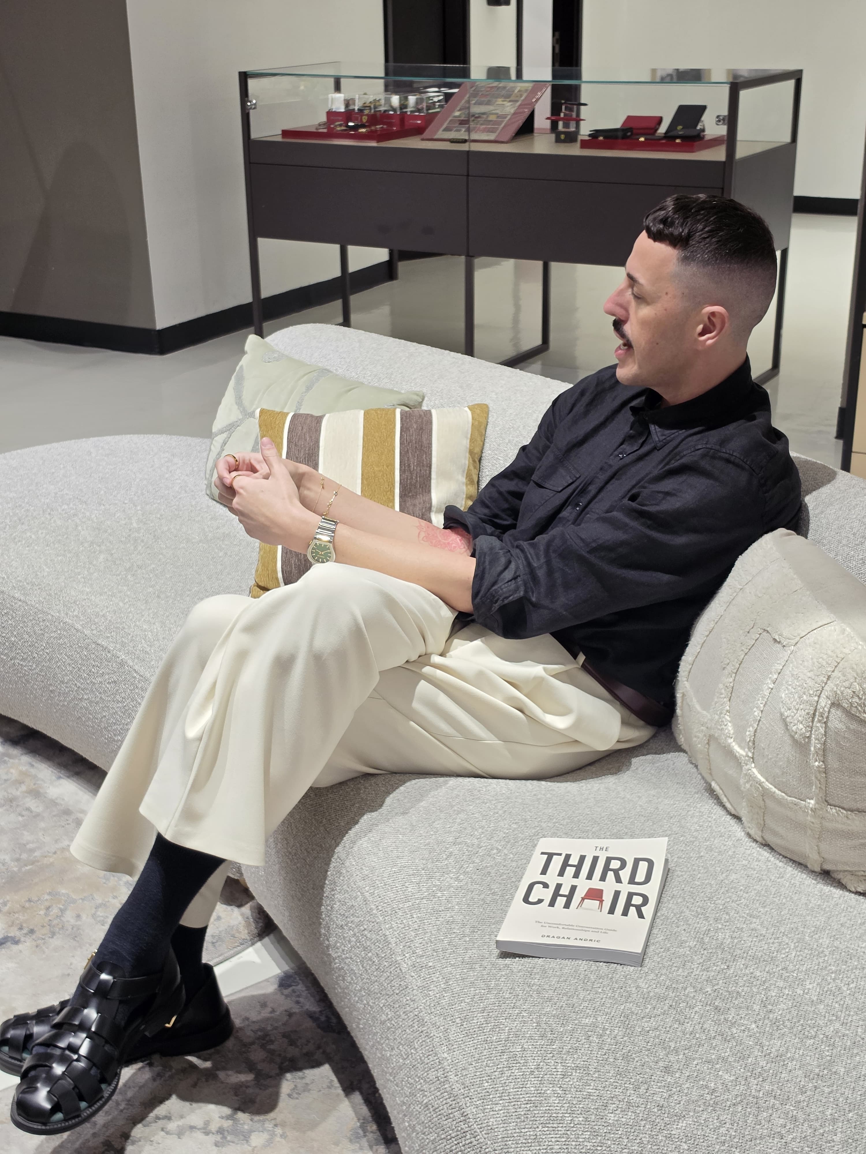 Dragan Andric seated in conversation, with The Third Chair beside him.